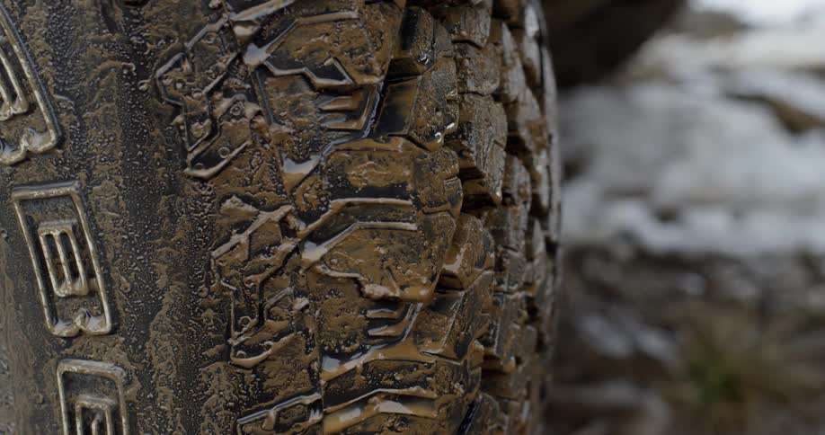 Mud sits on the tread of truck tires