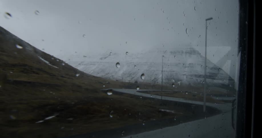 Looking out the window of a vehicle as it drives in the rain
