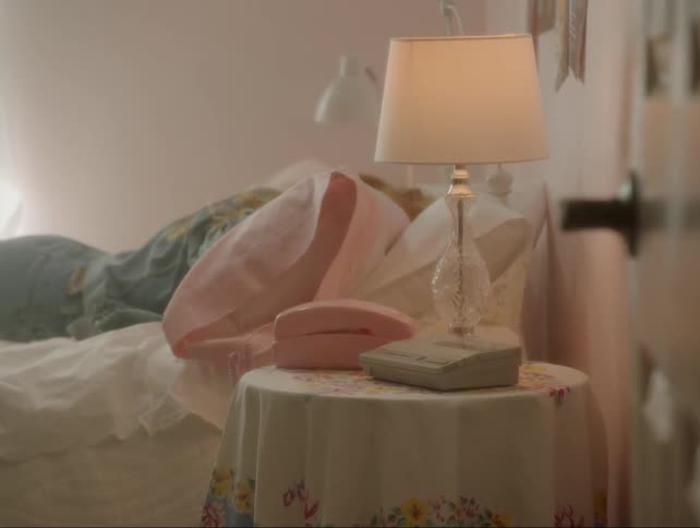Girl falls face forward onto bed