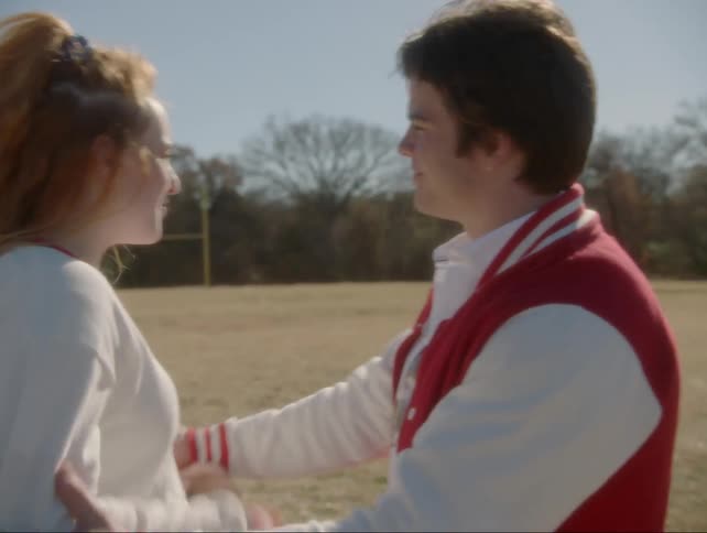 Two teenagers argue in a field