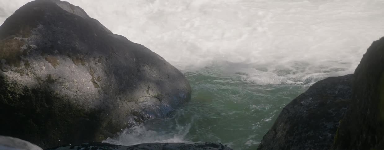 Waves crash against rocks