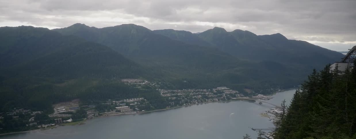 Clouds are hanging over a coastal city during the day