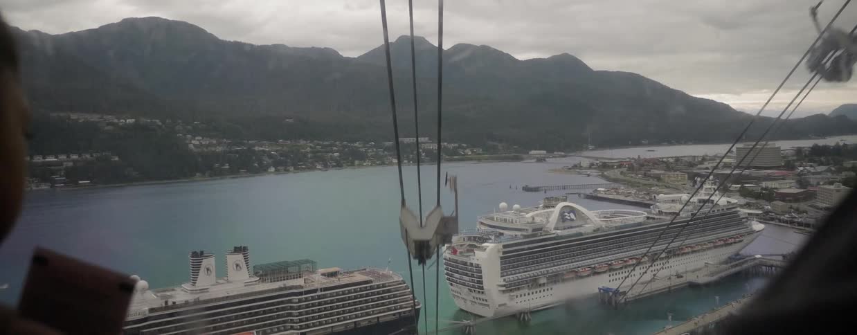 Person looks down on cruise ships from a lift