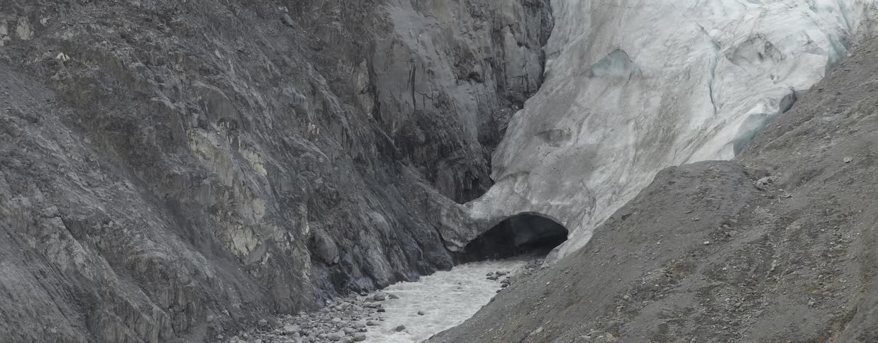 Water melting and flowing out from under an ice glacier