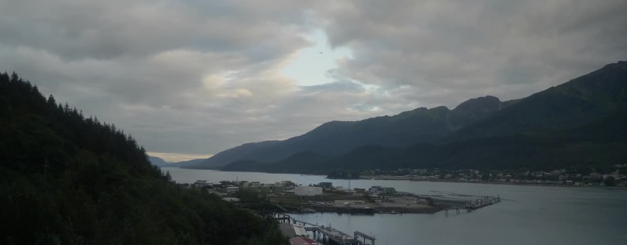 Clouds hover over a mountain lake
