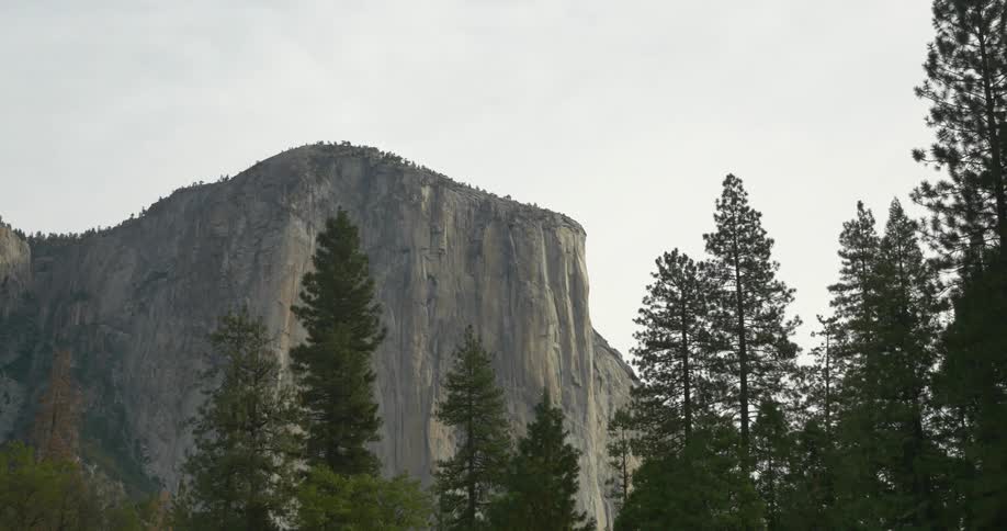 View from below to the top of a mountain on a cloudy day