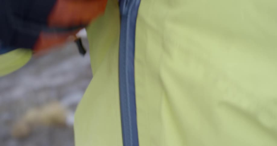 Woman zips up a jacket