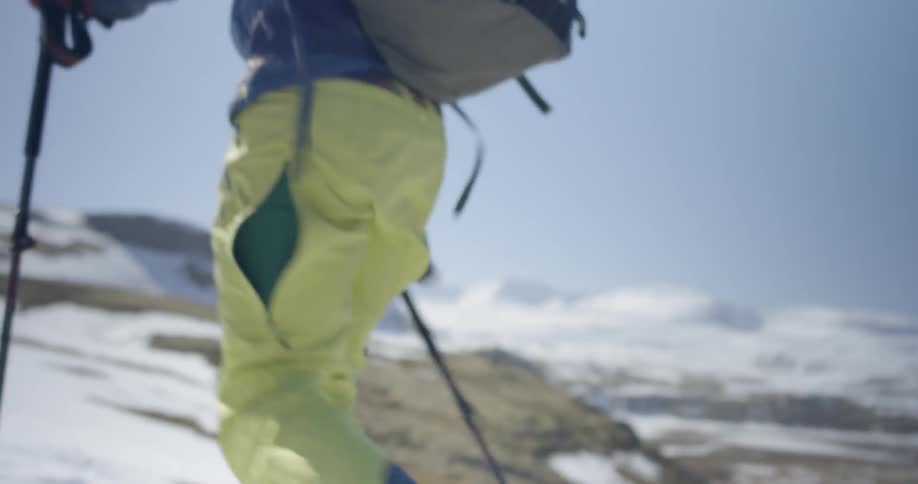 A skier walks up a mountainside