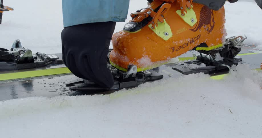 A skier latches their binding on a backcountry ski