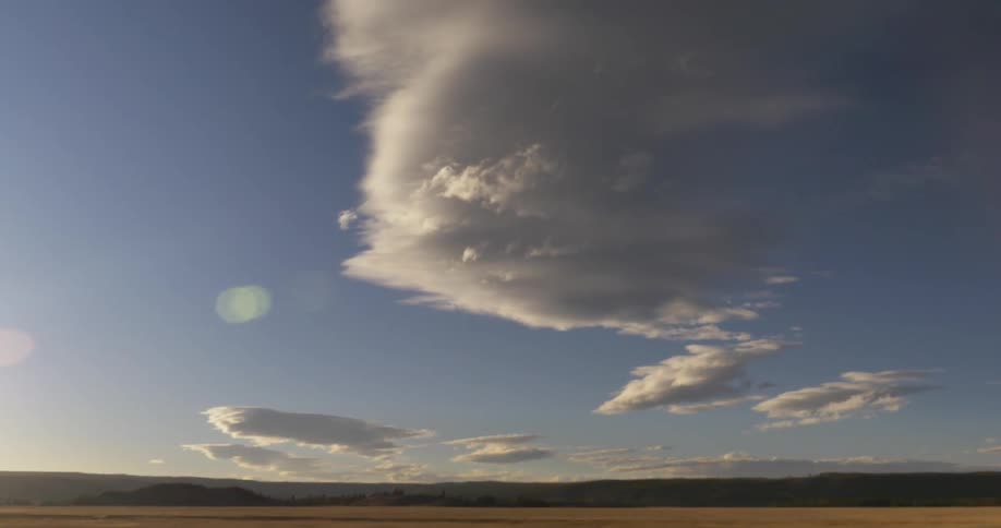 Large field with some clouds above
