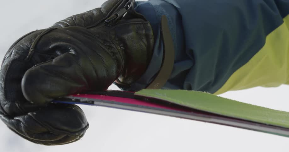 A person applies skins to skis