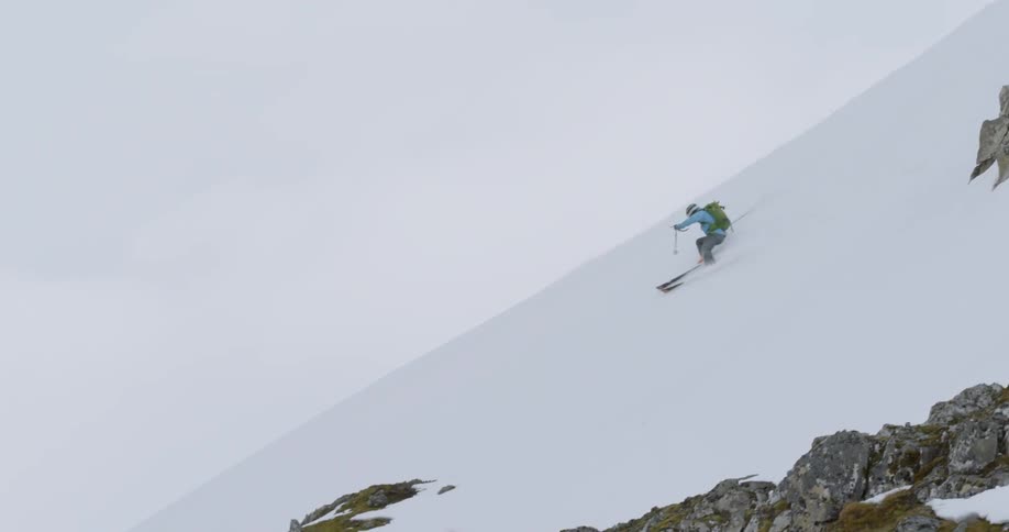 A skier glides down an icy ridge