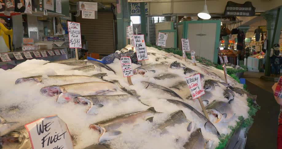 Table filled with large fish for sale in ice