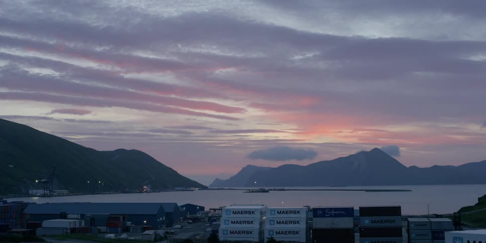 The sun is setting over an ocean town