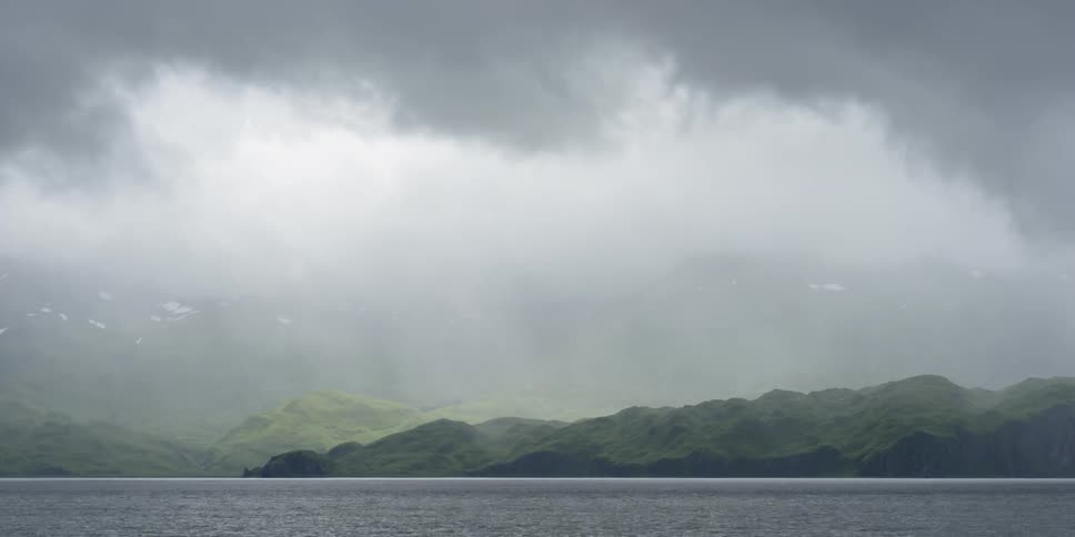 Timelapse of low clouds and fog over a lake