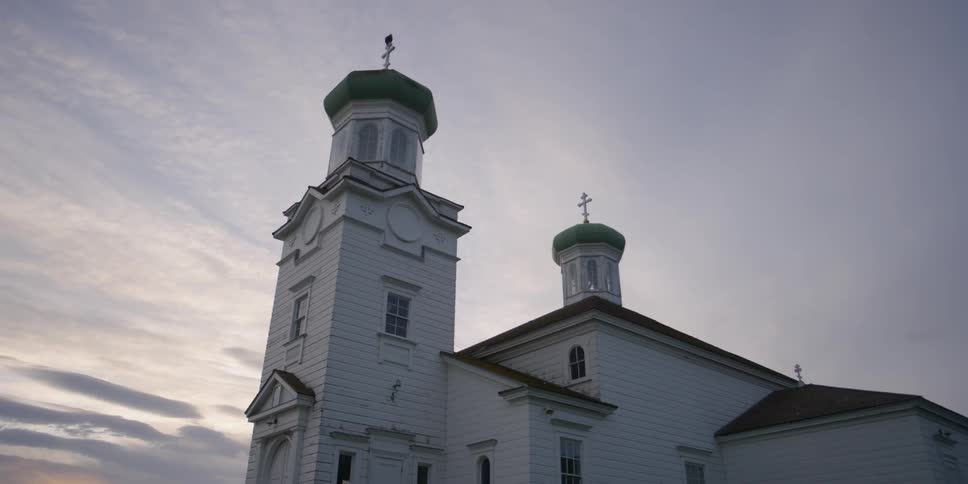 Spires of a country church against cloudy sky