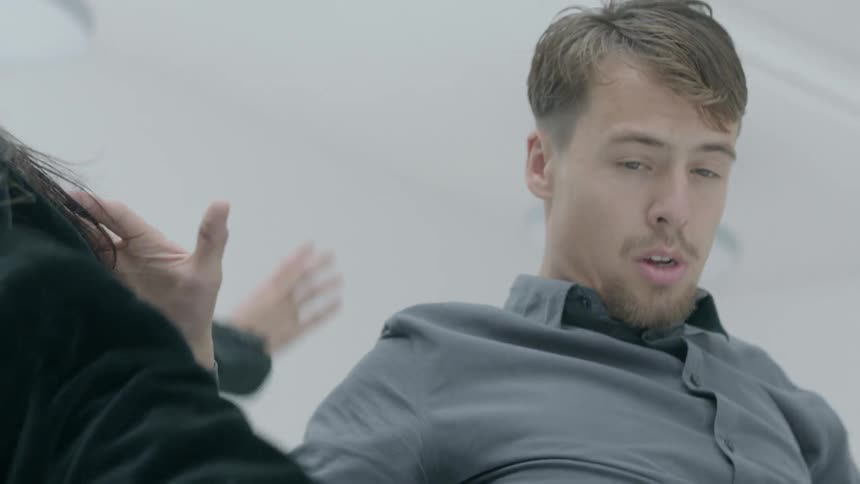 Two men dancing in a brightly lit room