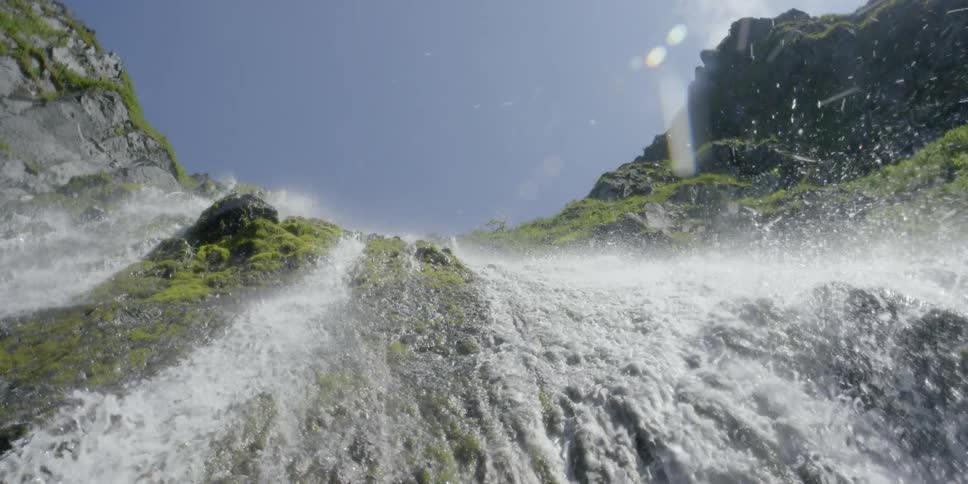Water flows down a waterfall on a sunny day