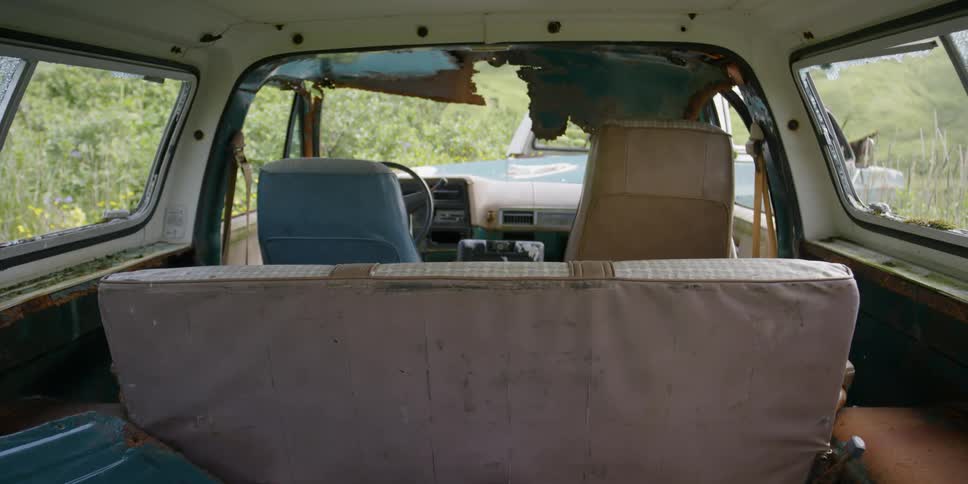 The interior of an abandoned car is rotting out