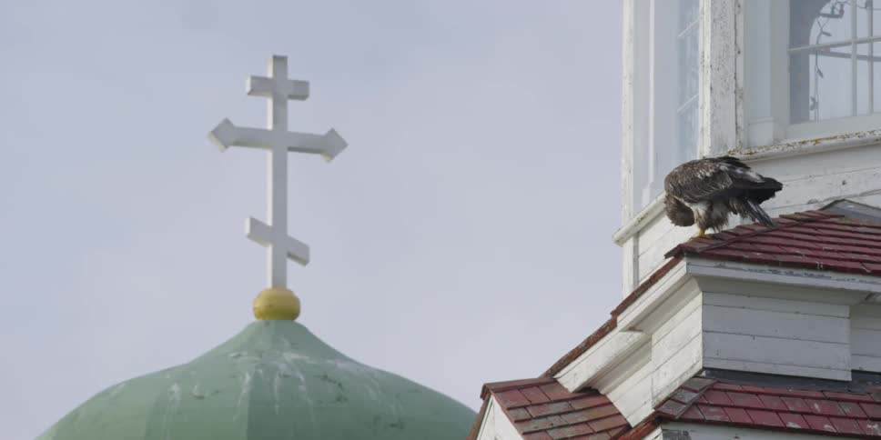 A cross sits on top of a church steeple