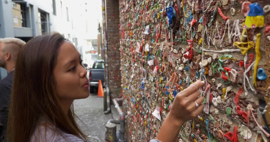 Woman attaching something on a decorated wall