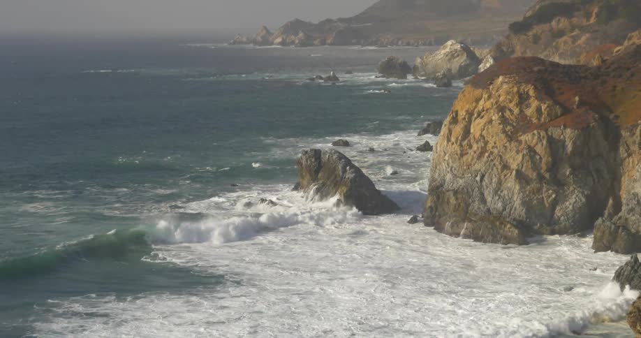 Waves crashing on a rocky cliff side