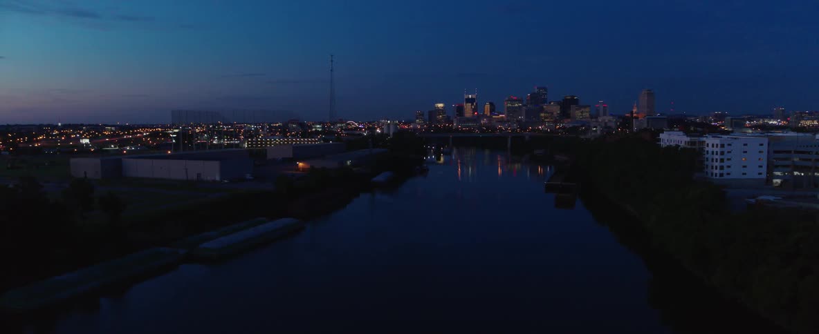 A large city is viewed from a small river