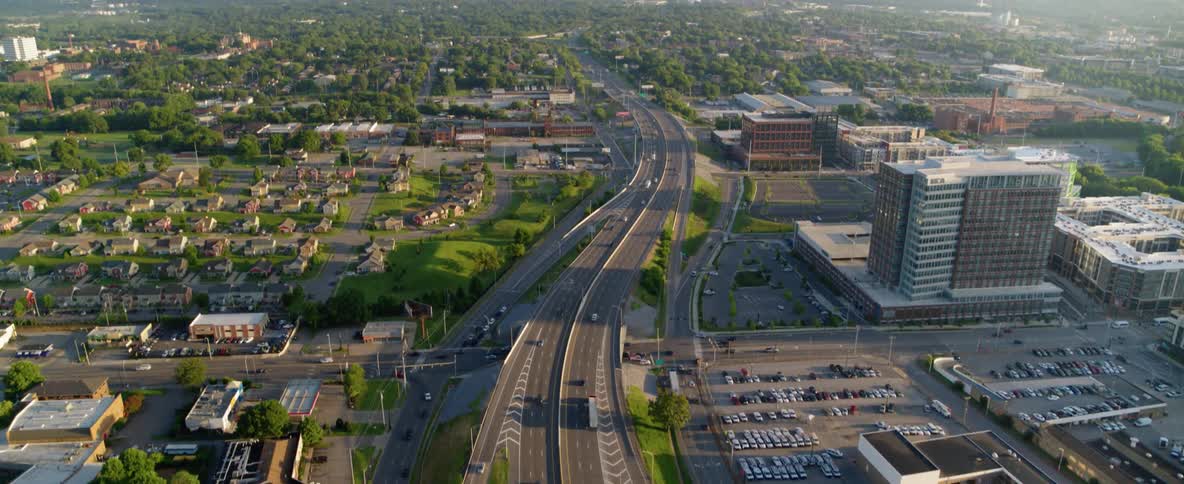 Cars drive on a city street