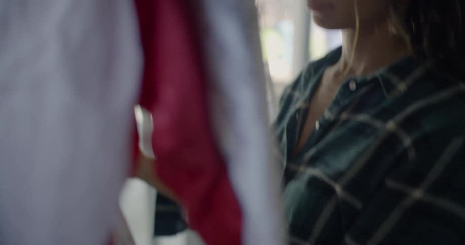 A woman is standing in a room examining a sports jersey covered in signatures