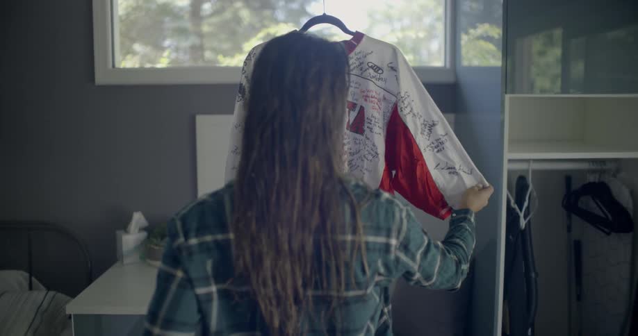 A woman looks at an autographed jersey