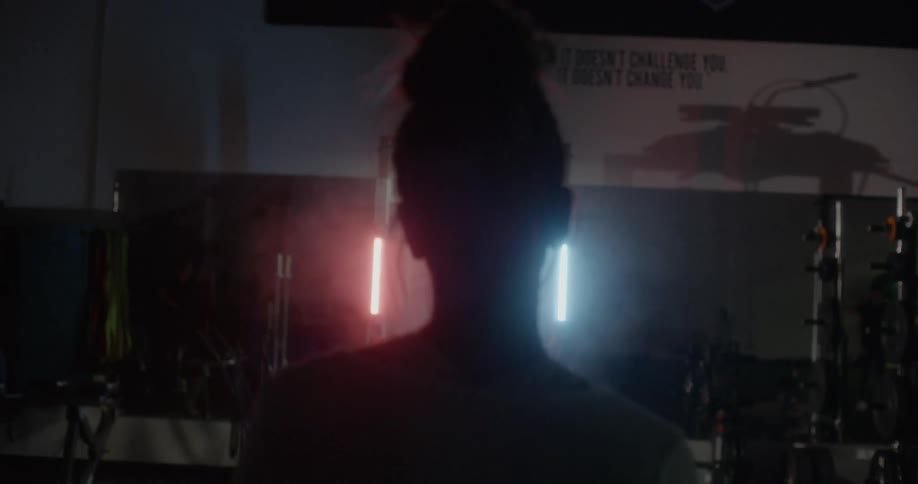 A woman is standing between a red and blue light