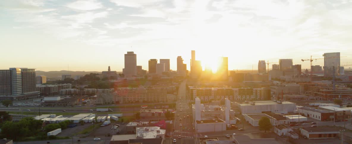 The shines between tall city buildings