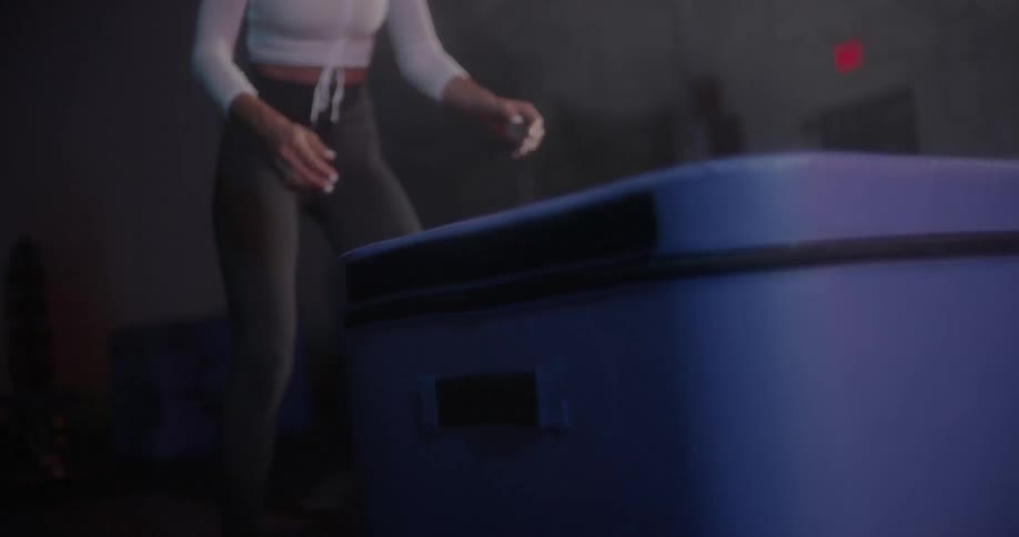 A woman is jumping up and down on a step