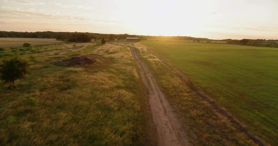 The sun sets over rural fields