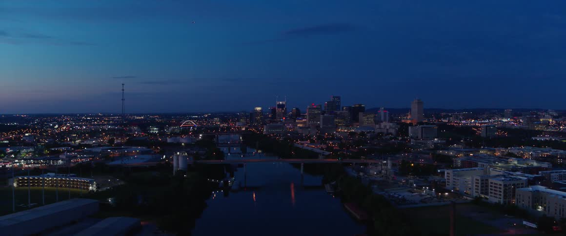 A river cuts through a city at night