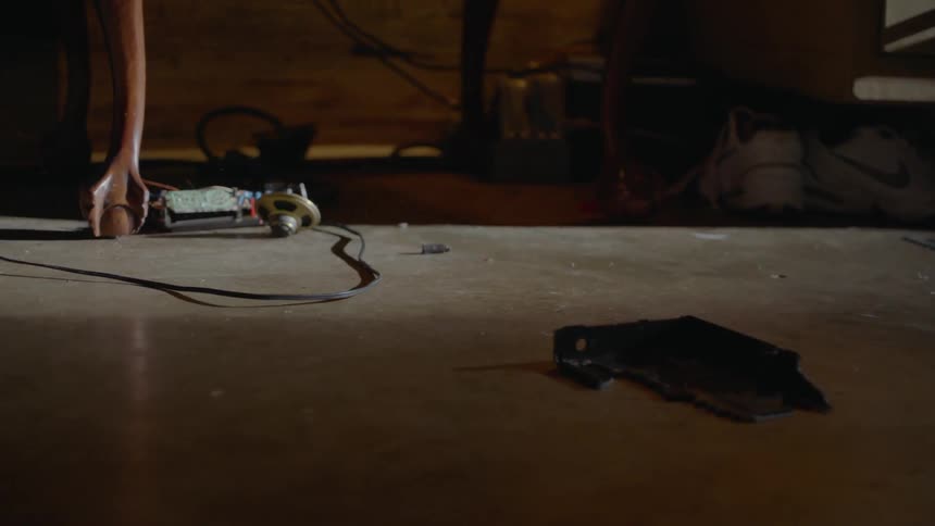 An alarm clock falls and breaks on the ground