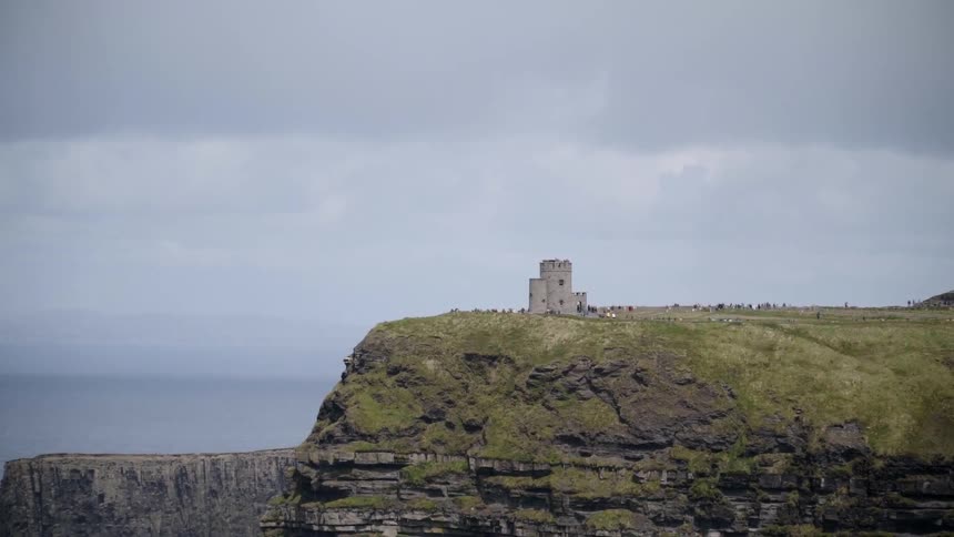 Old castle stands on the edge of an oceanside cliff