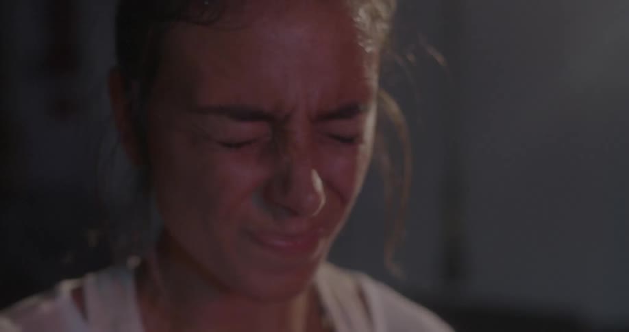 Woman breathes heavily while exercising