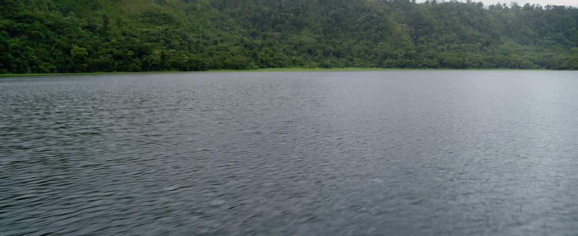 The water is rough in this lake surrounded by hills