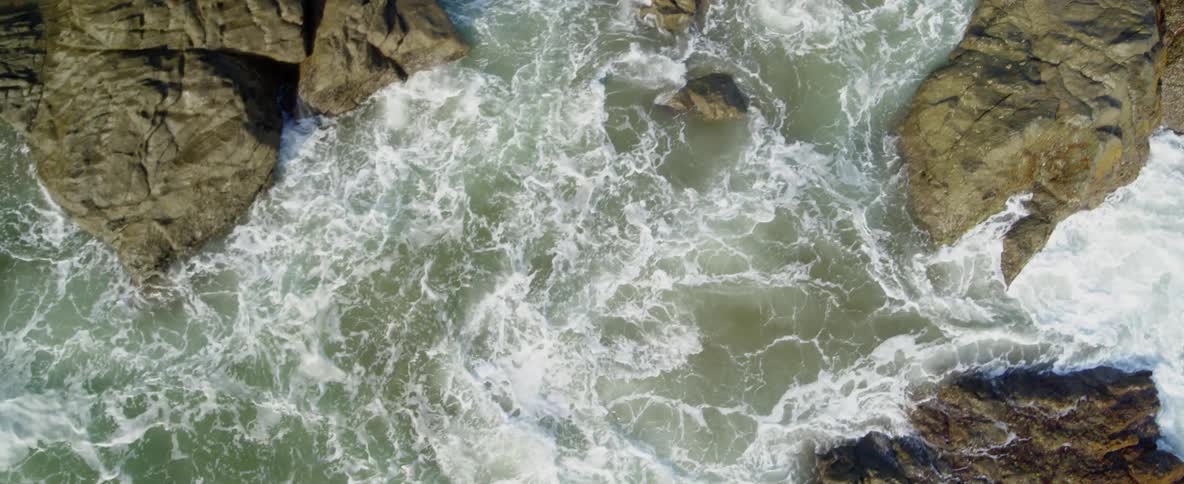 Ocean waves crash into rocks