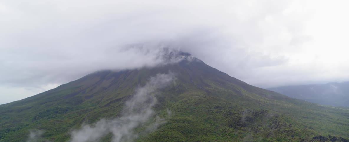 A mountain top of surrounded by fog