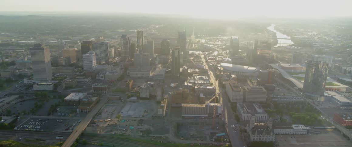 The sun is shining through the clouds on the city