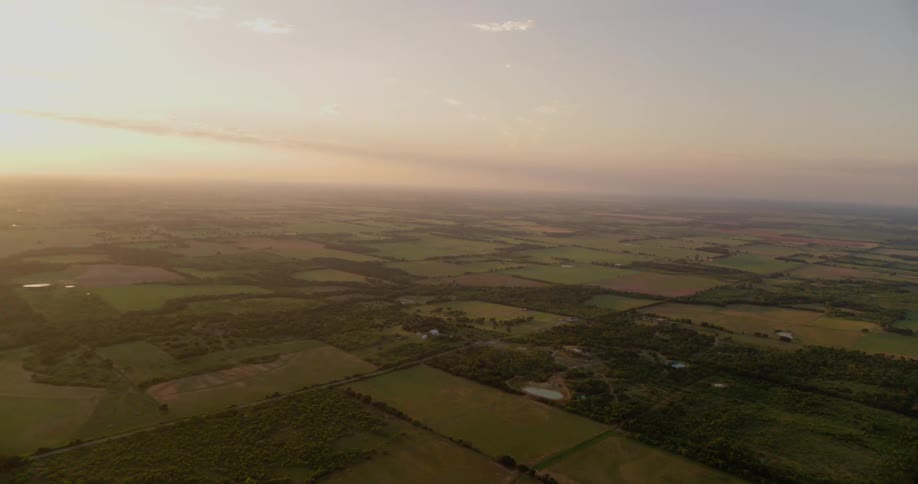 The sun sets over rural fields