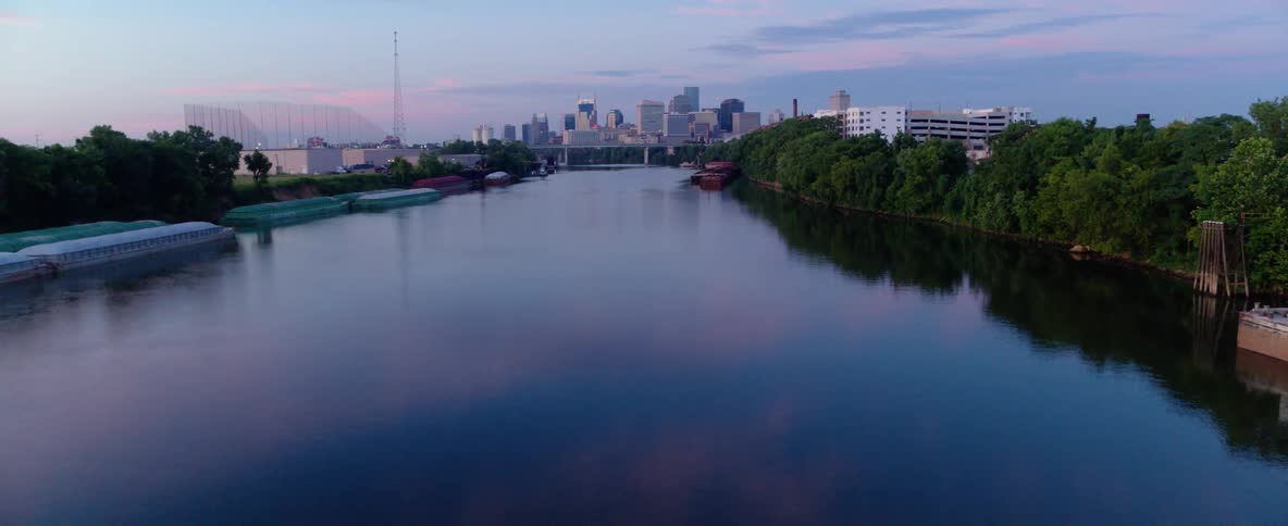 A riverside city at sunrise