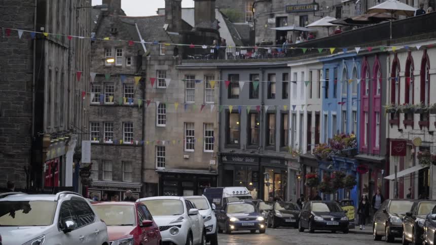The car drives down the city street