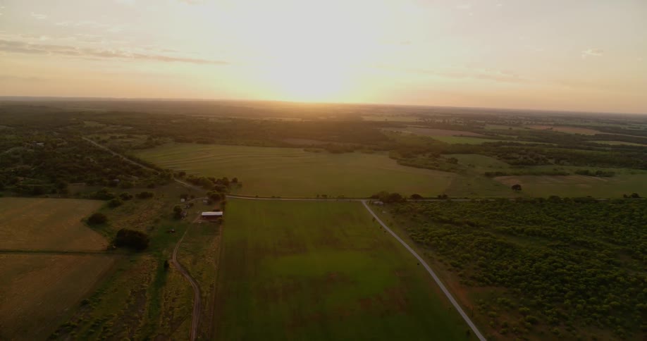 The sun is rising over a farming community