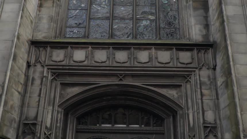 Man paces in front of cathedral doors