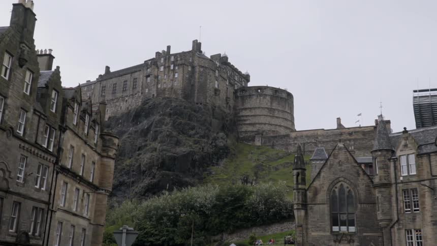A castle sets on top of a hill overlooking the town
