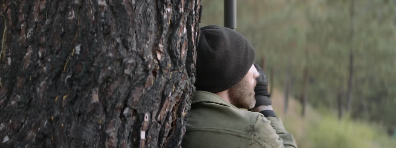 A man turns and fires a gun