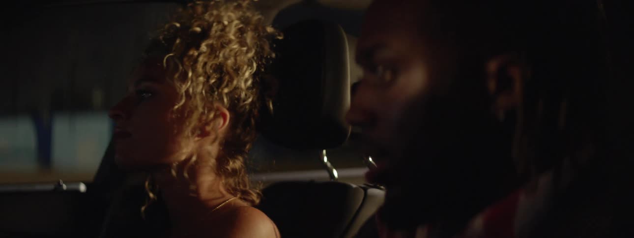 A couple riding in a car at night